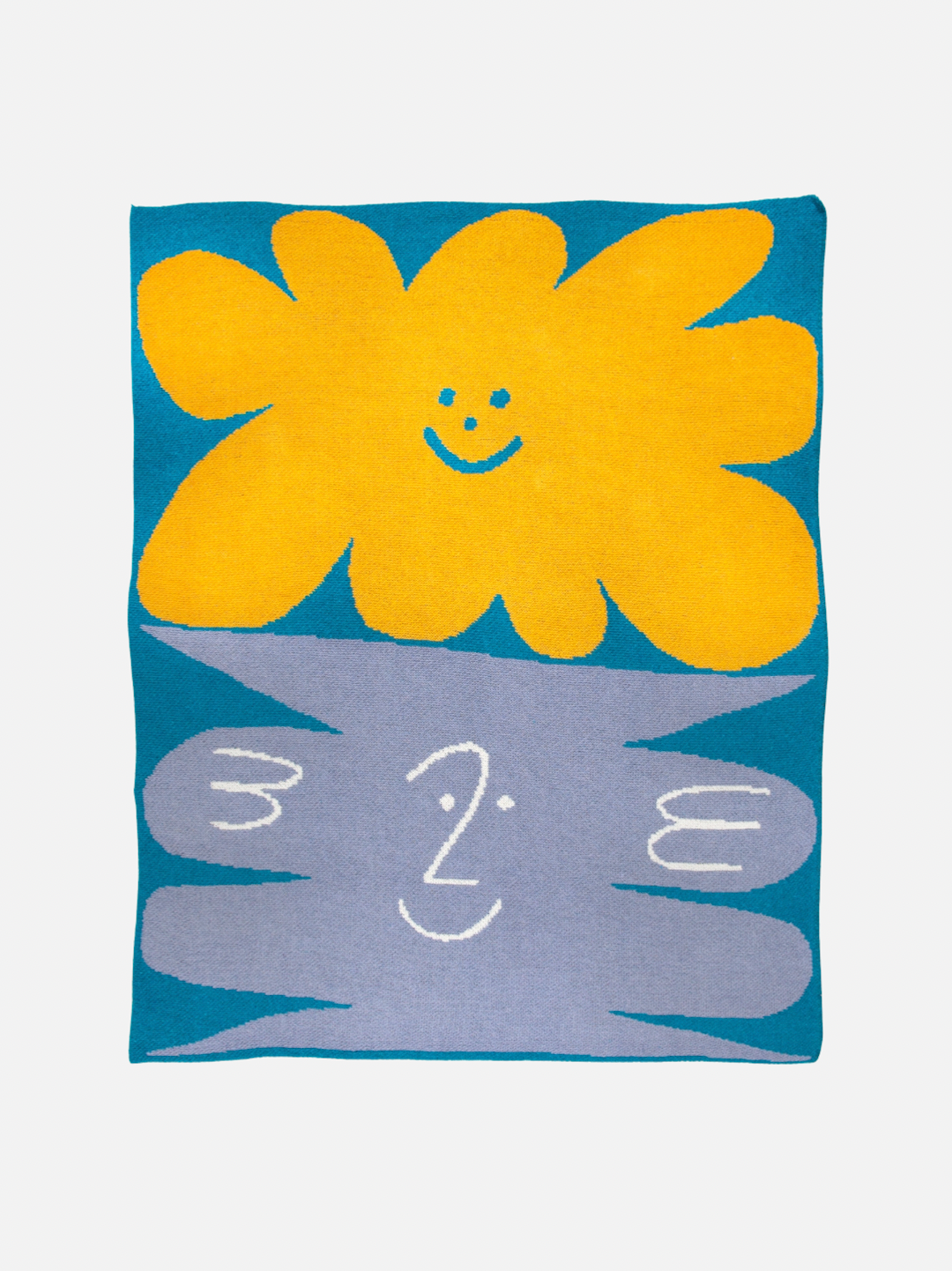 A mini blanket with yellow and gray smiley faces on a sky blue background