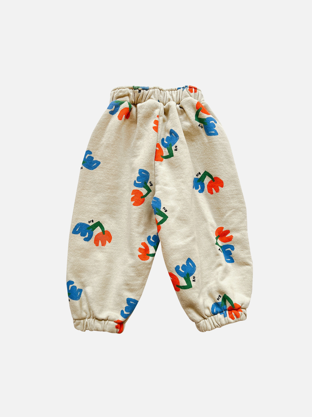 Pair of kids' sweatpants with blue and red flowers on an ecru background, back view