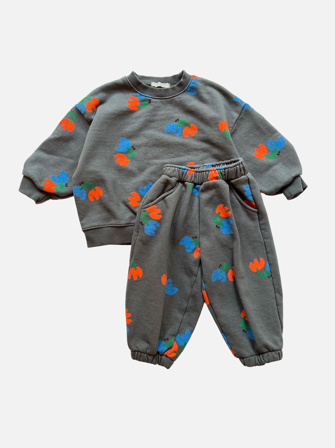 Set of kids' sweatpants and top in slate gray, printed with blue and orange flowers, front view