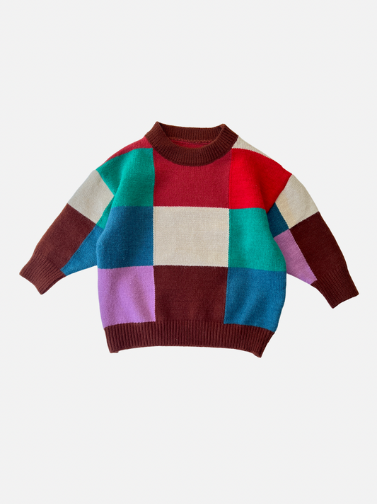 Image of A kids' colorblock sweater in shades of green, blue, red, pink, cream and brown