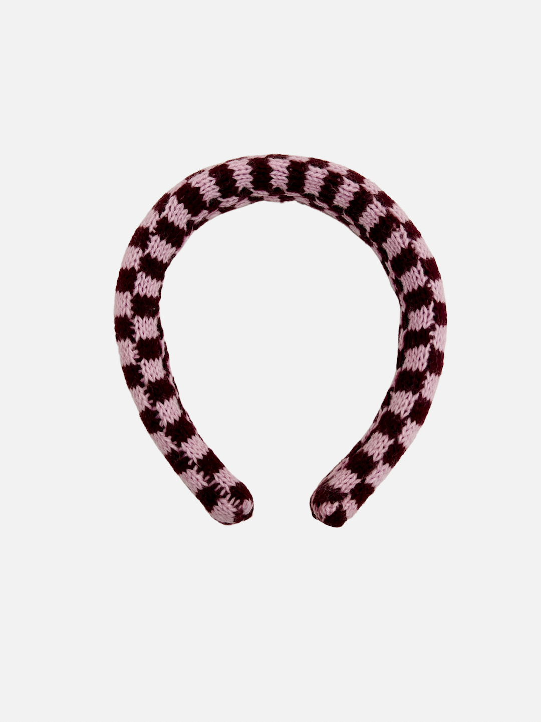 A kids' knitted headband in a pink and dark red check