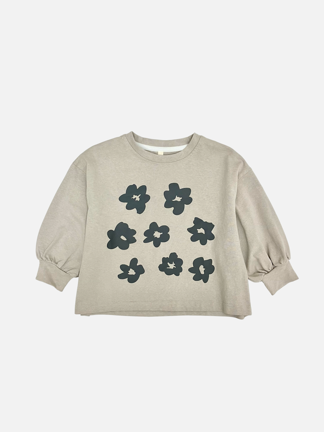 A soft gray kids' tee shirt with a pattern of dark gray flowers, sleeves gathered at the cuffs, front view