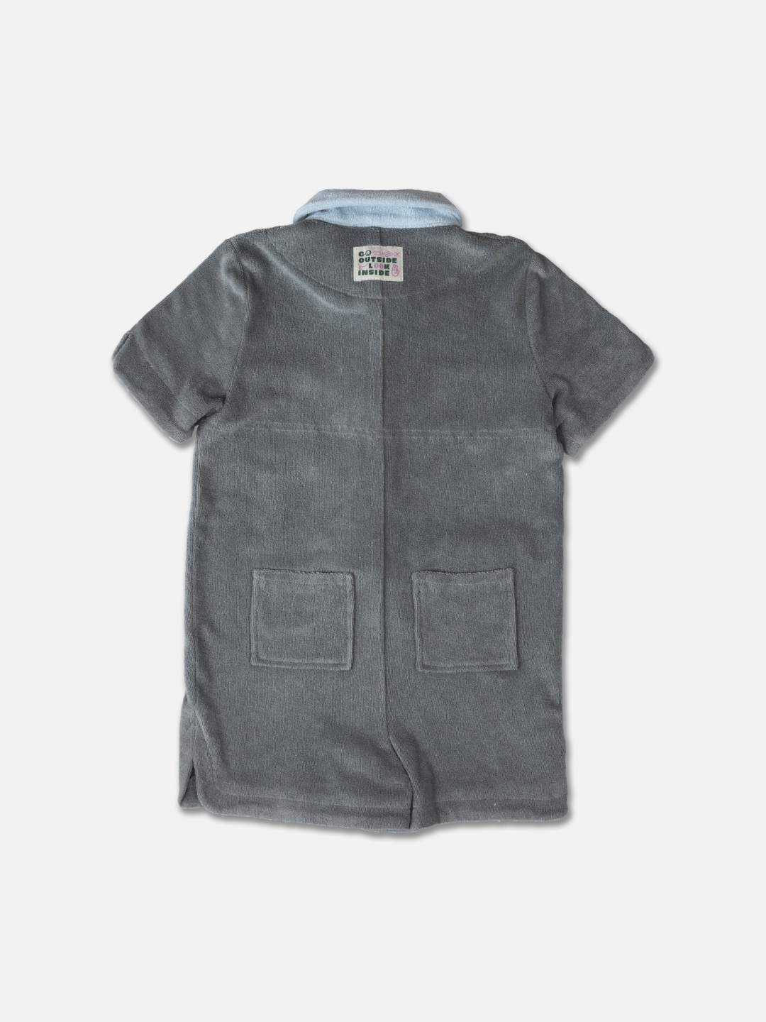 Rear view of a kids' jumpsuit in pale gray with blue collar and two back pockets